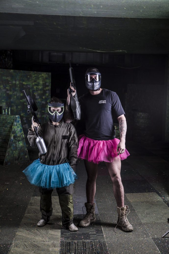 father and daughter posing in paintball gear